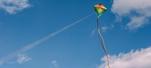 Rainbow kite in the air with clouds