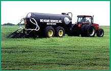 Description: tractor spraying sludge